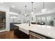 Bright kitchen featuring a large island with a farmhouse sink and stainless steel appliances at 1365 Tappie Toorie Cir, Lake Mary, FL 32746