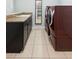 Laundry room includes granite countertop, sink and modern burgundy washer and dryer at 1365 Tappie Toorie Cir, Lake Mary, FL 32746