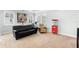 Comfortable living room with a black sofa, ample natural light, and a unique Coca-Cola themed popcorn machine at 1365 Tappie Toorie Cir, Lake Mary, FL 32746