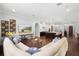 Spacious living room connected to the kitchen, featuring hardwood floors, and an entertainment center at 1365 Tappie Toorie Cir, Lake Mary, FL 32746