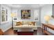 Bright living room with hardwood floors, sofa, and modern decor at 1365 Tappie Toorie Cir, Lake Mary, FL 32746