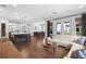 Open-concept living room and kitchen area with hardwood floors, and natural light through French doors at 1365 Tappie Toorie Cir, Lake Mary, FL 32746