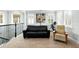 Cozy upstairs living space featuring a comfortable black sofa, chair, and a nostalgic popcorn machine at 1365 Tappie Toorie Cir, Lake Mary, FL 32746