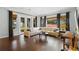 Living room showcasing hardwood floors, a comfortable sectional sofa, and a view of the backyard at 1365 Tappie Toorie Cir, Lake Mary, FL 32746