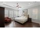 Relaxing main bedroom with a tray ceiling, plantation shutters, and warm neutral tones at 1365 Tappie Toorie Cir, Lake Mary, FL 32746
