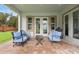 Covered patio boasts blue chairs, a coffee table, a grill and an outdoor dining area at 1365 Tappie Toorie Cir, Lake Mary, FL 32746