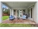 Brick paved outdoor patio with seating featuring blue chairs, a coffee table and string lights at 1365 Tappie Toorie Cir, Lake Mary, FL 32746