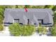 Overhead view of townhome roofs, displaying a complex layout and mature trees, marked with a red arrow at 14231 Desert Haven St # Ge, Windermere, FL 34786
