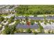Aerial shot of townhomes with dark roofs surrounded by trees, highlighted by a red arrow at 14231 Desert Haven St # Ge, Windermere, FL 34786