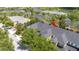Aerial view of a townhome complex with well-maintained roofs and landscaping, highlighted with a red arrow at 14231 Desert Haven St # Ge, Windermere, FL 34786