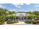Charming community clubhouse with a covered porch, complemented by manicured landscaping and palm trees at 14231 Desert Haven St # Ge, Windermere, FL 34786