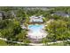 Aerial view of a community pool and lounge area with a large pool surrounded by palm trees and a covered lounge at 14231 Desert Haven St # Ge, Windermere, FL 34786