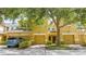 Inviting townhome with a warm yellow exterior, featuring well-maintained landscaping and attached garages at 14231 Desert Haven St # Ge, Windermere, FL 34786