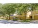 Street view of townhomes with a car parked, showcasing the well-kept facades and mature landscaping at 14231 Desert Haven St # Ge, Windermere, FL 34786