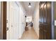 Hallway featuring tile floors, a dark brown door, and an open view of the living room at 14231 Desert Haven St # Ge, Windermere, FL 34786