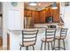 Close-up of eat-in kitchen featuring stainless steel appliances, bar seating and stylish pendant lighting at 14231 Desert Haven St # Ge, Windermere, FL 34786