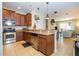 Kitchen with granite countertops, stainless steel appliances, and dark wood cabinets at 14231 Desert Haven St # Ge, Windermere, FL 34786