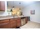 Kitchen with a breakfast bar, stainless steel appliances, granite countertops, and wooden cabinetry at 14231 Desert Haven St # Ge, Windermere, FL 34786