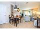 Open-concept living and dining area with sliding glass doors to the outdoor patio at 14231 Desert Haven St # Ge, Windermere, FL 34786