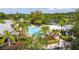 Overhead view of a community pool area featuring palm trees, lounge chairs, and well-maintained landscaping at 14231 Desert Haven St # Ge, Windermere, FL 34786