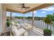 Relaxing balcony overlooking a serene lake, furnished with comfortable seating and ceiling fan at 1425 Riviera Dr, Kissimmee, FL 34744