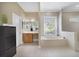 This bathroom features a soaking tub, walk-in shower, and neutral tiling at 1425 Riviera Dr, Kissimmee, FL 34744