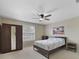This bedroom features a dark wardrobe and ceiling fan at 1425 Riviera Dr, Kissimmee, FL 34744