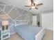 Neutral bedroom with decorative grey accent wall, carpeted floors, and a ceiling fan at 1425 Riviera Dr, Kissimmee, FL 34744