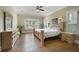 Spacious bedroom featuring hardwood floors, plantation shutters, and elegant crown molding at 1425 Riviera Dr, Kissimmee, FL 34744