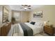 Neutral bedroom with decorative wall art, carpeted floor, and a large bed with accent pillows at 1425 Riviera Dr, Kissimmee, FL 34744