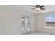 A light and airy bedroom with a ceiling fan and private access to a balcony at 1425 Riviera Dr, Kissimmee, FL 34744