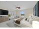 A bright bedroom with a ceiling fan, and carpeted floors features french doors with a view at 1425 Riviera Dr, Kissimmee, FL 34744