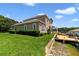 Lakeside house featuring a well manicured lawn and a private dock with a boat house and boat lift at 1425 Riviera Dr, Kissimmee, FL 34744