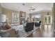 Bright living room with fireplace, large windows, and hardwood floors, perfect for relaxing or entertaining at 1425 Riviera Dr, Kissimmee, FL 34744