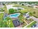 Aerial view of community amenities, including a swimming pool, playground, and lakeside location at 1429 Carey Glen Cir, Orlando, FL 32824