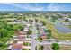 An aerial view shows this single Gathering home nestled in a quiet neighborhood with a partial view of the pond at 1429 Carey Glen Cir, Orlando, FL 32824