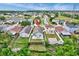 Aerial view shows a fenced backyard with a patio and shed, with views of the pond and green trees at 1429 Carey Glen Cir, Orlando, FL 32824
