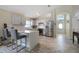 Bright kitchen with stainless steel appliances, breakfast bar, and seamless flow to the front entryway at 1429 Carey Glen Cir, Orlando, FL 32824