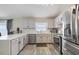 Modern kitchen featuring stainless steel appliances, quartz countertops, and wood look tile flooring at 1429 Carey Glen Cir, Orlando, FL 32824