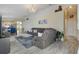Living room features a recliner, sofa, and an open floor plan leading to the kitchen at 1429 Carey Glen Cir, Orlando, FL 32824