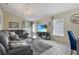 Comfortable living room with plush seating, a chandelier, and a large screen television at 1429 Carey Glen Cir, Orlando, FL 32824