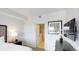 Bright bedroom with a sleek dresser, contemporary artwork, and an ensuite bathroom at 14501 Grove Resort Ave # 2440, Winter Garden, FL 34787