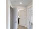 Hallway in a modern house that leads to the kitchen and bedroom at 14501 Grove Resort Ave # 2440, Winter Garden, FL 34787