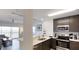 Open concept kitchen with modern cabinets and a large living room with natural light at 14501 Grove Resort Ave # 2440, Winter Garden, FL 34787