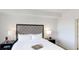 Cozy main bedroom featuring a tufted headboard, tray, lamps and bedside tables at 14501 Grove Resort Ave # 2440, Winter Garden, FL 34787