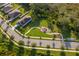 This aerial shows the home near a playground in a beautiful community with sidewalk-lined streets and mature trees at 16379 Blooming Cherry Dr, Groveland, FL 34736