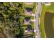 Aerial shot of homes nestled amongst a pond and lush greenery, creating a peaceful and scenic neighborhood setting at 16379 Blooming Cherry Dr, Groveland, FL 34736