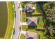 Aerial view of a well-situated home with a large yard, firepit, and a prime location near a scenic pond at 16379 Blooming Cherry Dr, Groveland, FL 34736
