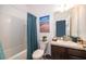 Bathroom features a shower and bath combo with a blue shower curtain at 16379 Blooming Cherry Dr, Groveland, FL 34736
