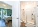 Shower with glass door next to the door to the bedroom at 16379 Blooming Cherry Dr, Groveland, FL 34736